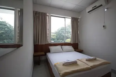 a bedroom with a bed with two towels on it at Bahagia Stay Georgetown in George Town