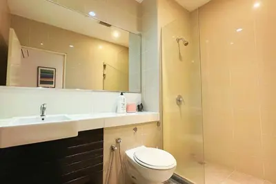 a bathroom with a toilet and a sink and a shower at 118 Island Plaza ComFy Seaview Suite in Tanjong Tokong