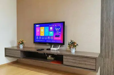 a flat screen tv sitting on a entertainment center at 118 Island Plaza ComFy Seaview Suite in Tanjong Tokong