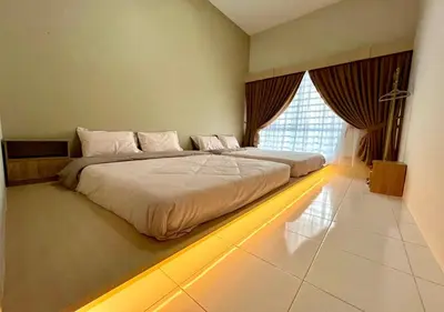 a bedroom with a large bed with a lighted floor at Polo Stay, 4 bedroom Single Storey house Ipoh for 10 pax in Ipoh