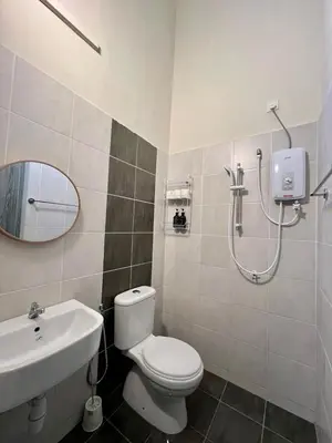 a bathroom with a toilet and a sink and a shower at Polo Stay, 4 bedroom Single Storey house Ipoh for 10 pax in Ipoh