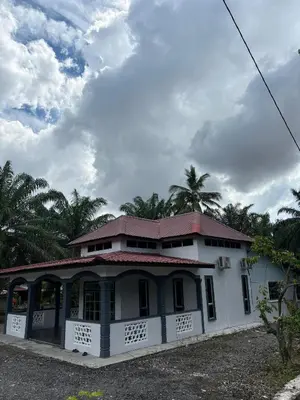 a white house with a red roof and palm trees at Bagan Serai Simpang Empat Parit Buntar Perak by 3SIBS in Bagan Serai