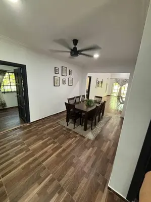 a dining room with a table and chairs and a ceiling fan at Bagan Serai Simpang Empat Parit Buntar Perak by 3SIBS in Bagan Serai