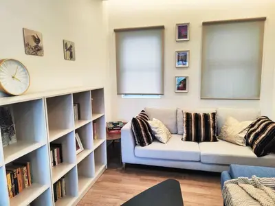 a living room with a couch and book shelves at #MyLuxeGetaway,Quintet Cameron Highlands in Cameron Highlands