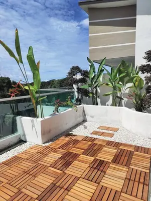 a wooden deck with a view of a house at #MyLuxeGetaway,Quintet Cameron Highlands in Cameron Highlands
