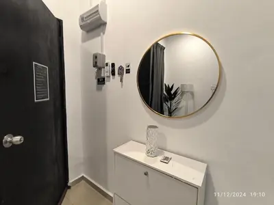a bathroom with a mirror and a white cabinet at a&h homestay in Teluk Intan