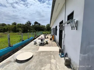 a row of tables on the side of a building at a&h homestay in Teluk Intan