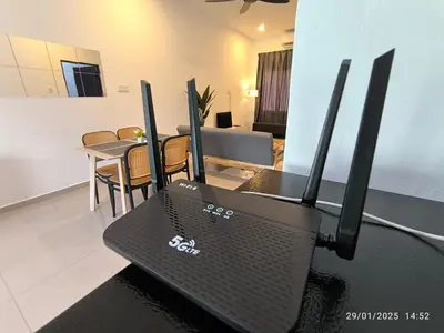 a room with a table with a gaming system at a&h homestay in Teluk Intan