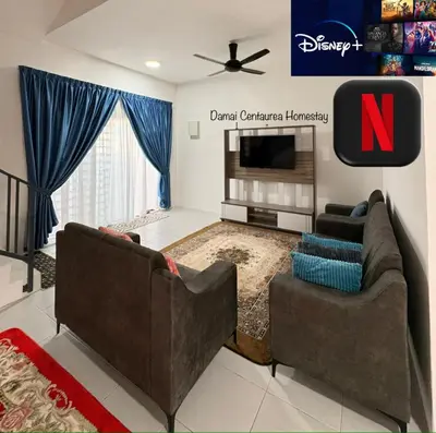 a living room with two couches and a tv at Damai Centaurea Homestay Utp Uitm Seri Iskandar Perak in Seri Iskandar