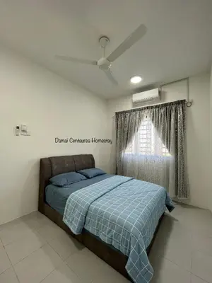 a bedroom with a bed with a blue blanket and a window at Damai Centaurea Homestay Utp Uitm Seri Iskandar Perak in Seri Iskandar