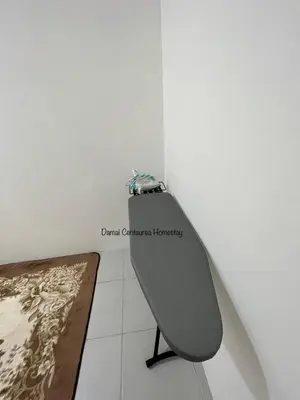 a bench in the corner of a room at Damai Centaurea Homestay Utp Uitm Seri Iskandar Perak in Seri Iskandar
