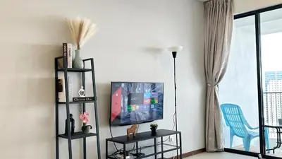 a living room with a tv and a blue chair at LM HomeyC 3BR Family Suite for 4-14 Pax with Nexflix & Coway Water Purifier in Tanjong Tokong