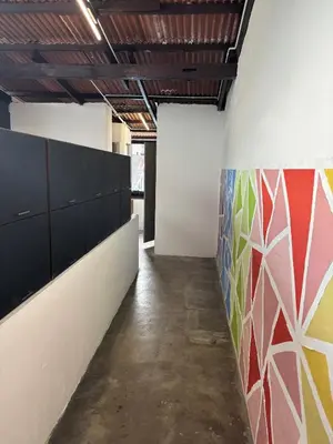 a hallway in an office with a colorful wall at Victoria Pods in George Town