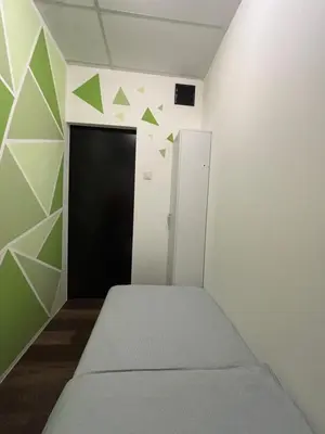 a bedroom with a door and green triangles on the wall at Victoria Pods in George Town