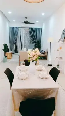 a room with a table with chairs and flowers on it at Crystal Heights Cozy House in Tupai