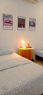 a bedroom with two beds and a table with a lamp at Crystal Heights Cozy House in Tupai