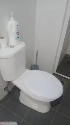 a bathroom with a white toilet in a room at Crystal Heights Cozy House in Tupai