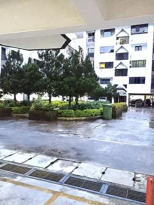 an empty parking lot with trees and a building at RF Parkview Residence Homestay in Tanah Rata