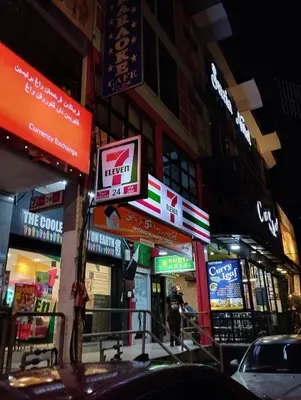 a busy city street with many signs on buildings at RF Parkview Residence Homestay in Tanah Rata