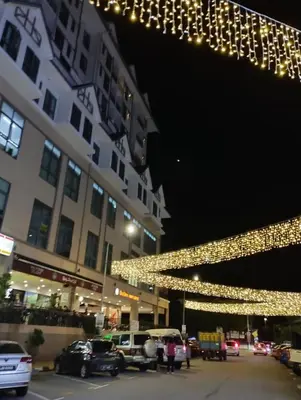 a group of lights hanging from a building at night at RF Parkview Residence Homestay in Tanah Rata