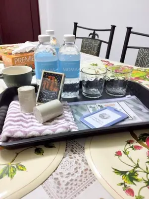 a tray with a book and bottles of water on a table at RF Parkview Residence Homestay in Tanah Rata