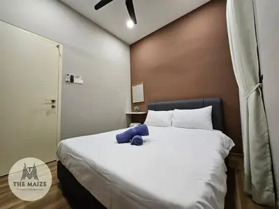 a bed with a blue teddy bear sitting on it at The Cove Hillside Residence - Grandiose Oasis in Ipoh