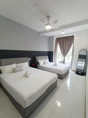 a bedroom with two beds and a ceiling fan at Dream 6 Emerald avenue in Cameron Highlands