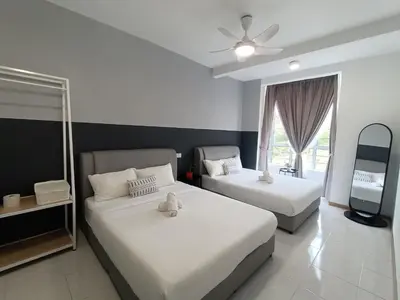 a bedroom with two beds and a ceiling fan at Dream 6 Emerald avenue in Cameron Highlands