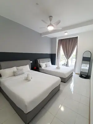 a bedroom with two beds and a ceiling fan at Dream 6 Emerald avenue in Cameron Highlands