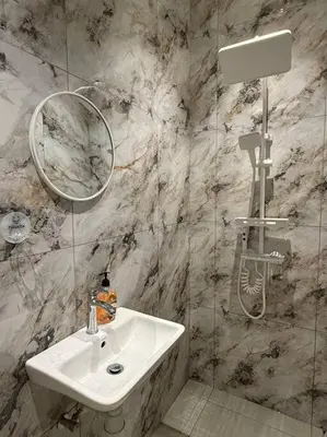a bathroom with a sink and a mirror and a shower at Live Like Your Home, Alma Bukit Mertajam in Bukit Mertajam