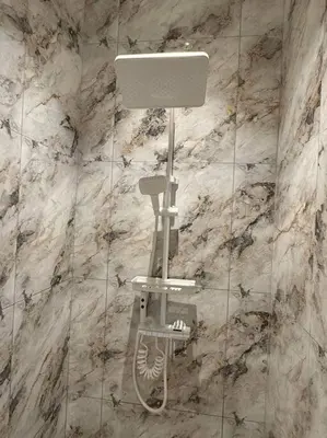 a shower in a bathroom with a marble wall at Live Like Your Home, Alma Bukit Mertajam in Bukit Mertajam