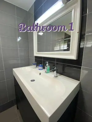a bathroom with a white sink and a mirror at Bergstein Taiping in Taiping