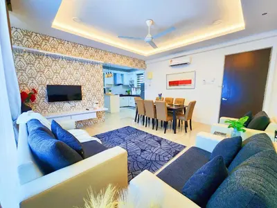 a living room with a couch and a dining room at Ipoh Meru Casa Kayangan 6 Pax Fully Air-Con Homestay in Ipoh