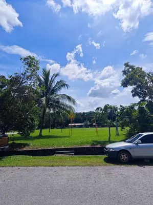 a car parked in front of a park with a palm tree at IlhamD' Homestay Kulim 5 Bedroom with 3 Toilet in Lunas