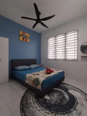 a bedroom with a bed with a ceiling fan at MyPutra Homestay Parit Buntar in Parit Buntar