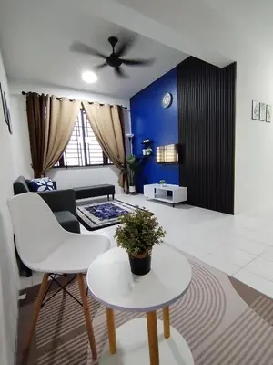 a living room with a couch and a ceiling fan at MyPutra Homestay Parit Buntar in Parit Buntar