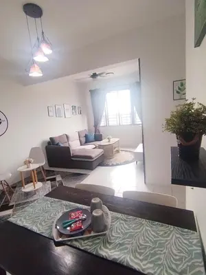 a living room with a couch and a table at MyPutra Homestay Parit Buntar in Parit Buntar