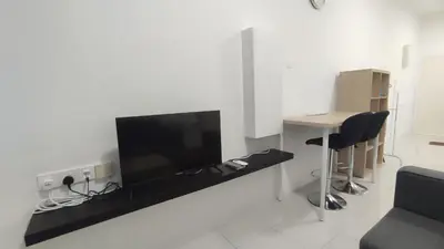 a living room with a flat screen tv on a wall at Sweet Home Ipoh in Ipoh
