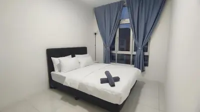 a bed with a cross on it in a bedroom at Sweet Home Ipoh in Ipoh