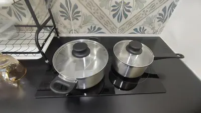 two pots sitting on top of a stove at Sweet Home Ipoh in Ipoh