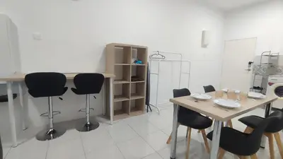 a room with a table and chairs and a table and a table and chairs at Sweet Home Ipoh in Ipoh