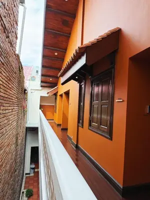 an empty balcony of a building with orange walls at Hotel Ban Sheng Teik in Ipoh
