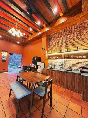a kitchen with a table and chairs in a room at Hotel Ban Sheng Teik in Ipoh