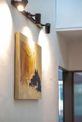 a painting hanging on a wall with a light at De Luma TheRumah 5 bedroom 3 bathroom in Bukit Mertajam