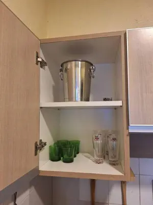 a cupboard with jars and a pot on top of it at Seaput Homes in Ayer Itam