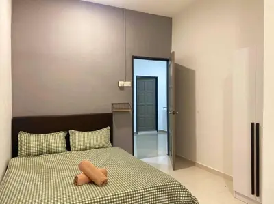 a bedroom with a bed with two pillows on it at 2 Storey Stylish Comfort Retreat ````AlmaImpianRia in Bukit Mertajam