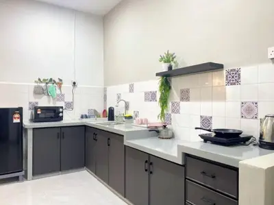 a kitchen with gray cabinets and white tiles at 2 Storey Stylish Comfort Retreat ````AlmaImpianRia in Bukit Mertajam