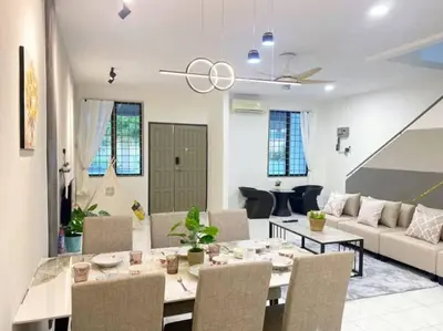 a dining room and living room with a table and chairs at 2 Storey Stylish Comfort Retreat ````AlmaImpianRia in Bukit Mertajam