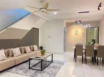a living room with a couch and a table at 2 Storey Stylish Comfort Retreat ````AlmaImpianRia in Bukit Mertajam