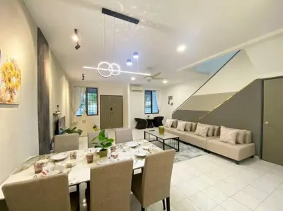 a dining room and living room with a table and couch at 2 Storey Stylish Comfort Retreat ````AlmaImpianRia in Bukit Mertajam